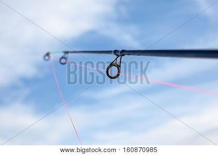 an red fishing line through the eye of the fishing line