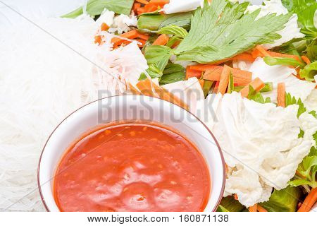 an bowl whit noodles vegetables carrots cabbage Chinese cabbage celery spicy sauce
