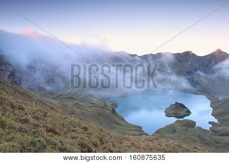 morning fog over alpine lake Schrecksee Germany