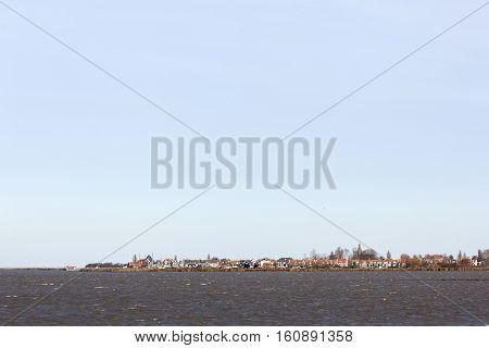 former island of Marken behind markermeer in the netherlands on sunny day