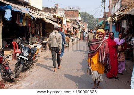CHITRAKOOT, INDIA - DEC 30, 2012 : Poor people walking on the Indian street at the beautiful sunny day on December 30, 2012 in India. Population of Chitrakoot is 22294. Males constitute 57 perc