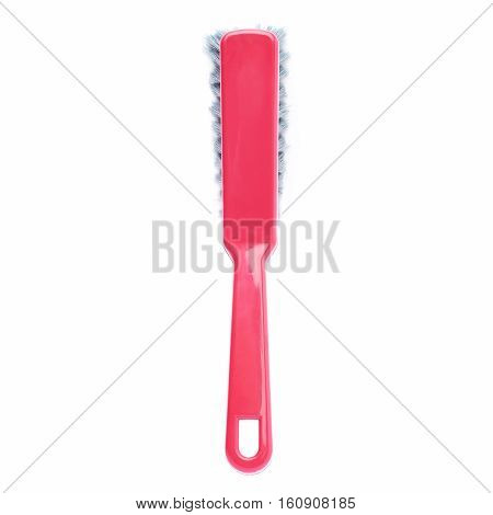 Single red plastic cleaning brush isolated over white background