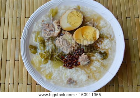 boiled rice in pickled Chinese cabbage and pork bone soup topping egg dressing fried chili paste