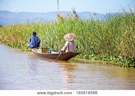 Inthas travel on boat in Inle, Myanmar. Travel by boat is the major transportation mean both local and tourists in Inle lake.
