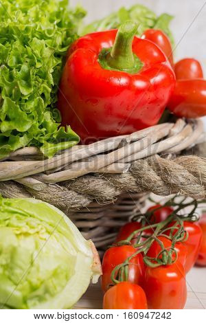 Ingredients for fresh spring healthy green salad- green and red frech lettuce salad leaves paprika tomatoes - healthy low calorie food