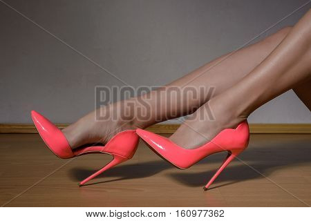 Woman Shapely Legs Wearing Pink Lacquered High Heel Shoes