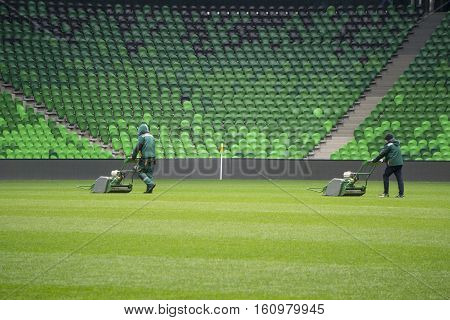 Mowing grass in a football and soccer stadium
