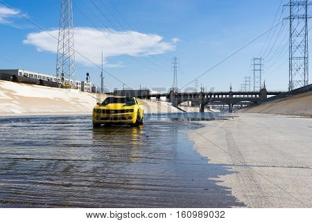 Los Angeles USA - September 28 2015: Chevrolet Camaro in Los Angeles river. Historic 6th Street viaduct bridge built in 1932 crossing the L.A. River.
