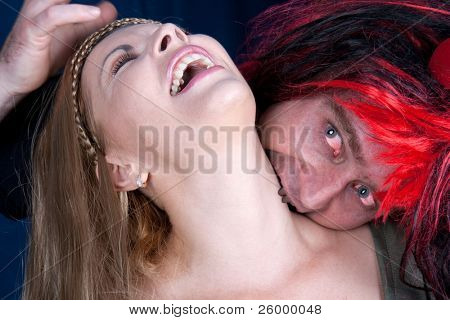 The count drakula bite a beautiful woman , studio shot
