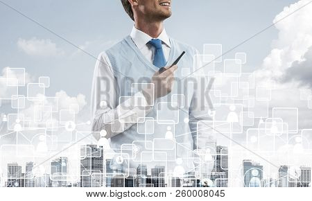 Double Exposure Of Confident And Young Businessman In Smart-casual Wear Smoking Pipe And Modern City
