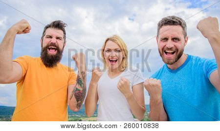 Celebrate Success. We Can Do It. Ways To Build Successful Team. Threesome Stand Happy With Raised Fi
