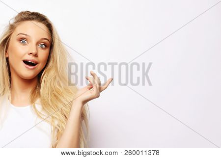 People, body language, emotions concept: Surprised terrified female gestures with uncertainty, stares at camera, puzzled as doesn`t know anwser on tricky question