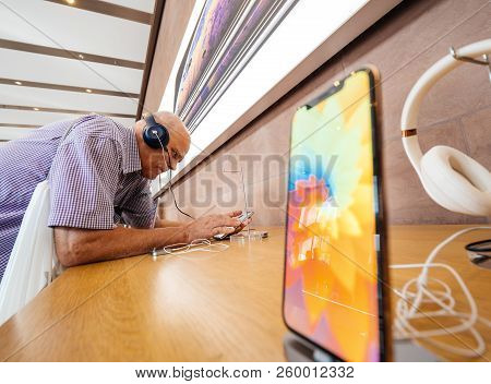 Strasbourg, France - Sep 21, 2018: Funny Curious Senior Man Testing Apple Beats By Dr Dre Headphones