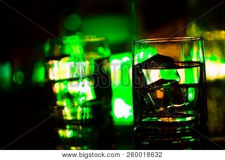 Colored Lighting Of Glasses In The Night Club Bar