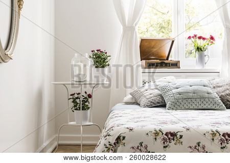 Rose Loving Woman's Bedroom Interior With A Bed With Flower Pattern Bedspread And Pastel Gray Pillow