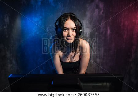 Girl Gamer In Headphones And With A Computer Mouse In Her Hand Streaming Playthrough Or Walkthrough 