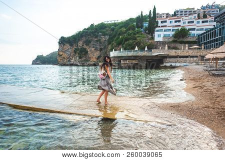 Woman Walking From Pier To Ricardova Glava Beach In Budva, Montenegro