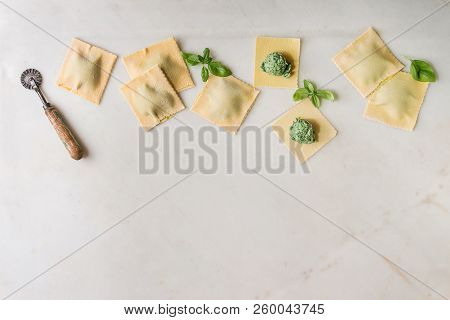 Homemade Raw Uncooked Italian Pasta Ravioli Staffed By Spinach Ricotta, Basil Leavrs, Pasta Cutter. 