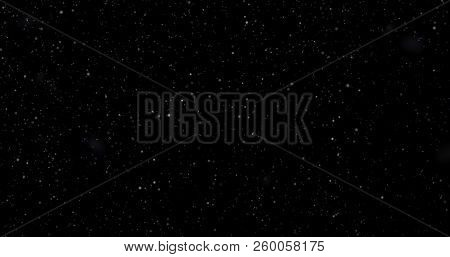 Flying Dust Particles On A Black Background