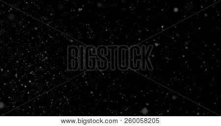 Flying Dust Particles On A Black Background
