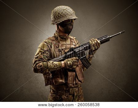 Soldier agent in a dark room with arms on his hand and gas mask