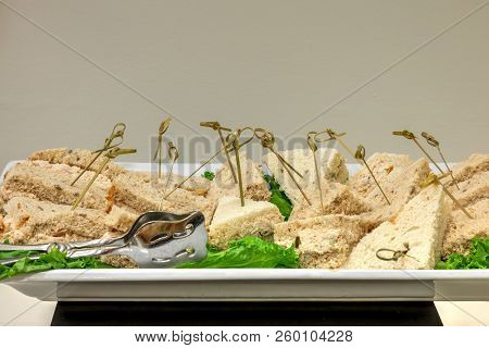 Tuna Sandwich Made With Tunafish, Mayo And Pickles On Wheat Bread At A Buffet.