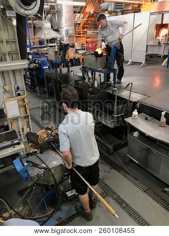 Man Maticulously Works On Glassblowing And Shaping  In The Factory Of House Of Waterford Crystal Fac