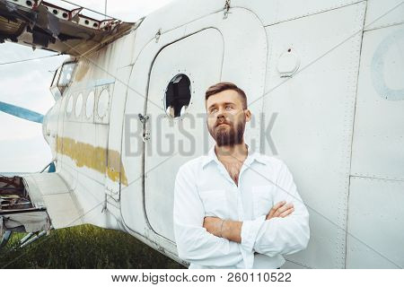 The Man In The Shirt Stands At The Old Plane