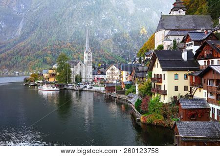 Scenic View Of Famous Hallstatt Mountain Village With Hallstatter Lake. Sunny Autumn Sunrise On Hall