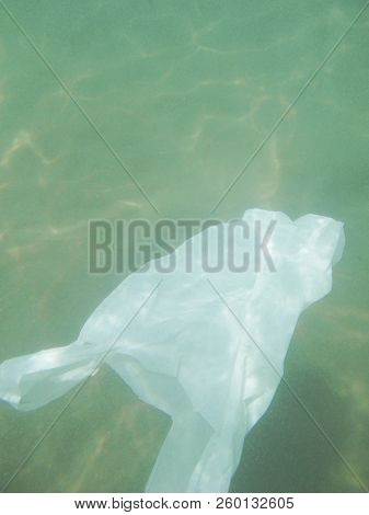 Plastic Bag Floating Into The Sea. Polluted Enviromental. Recycle Garbage