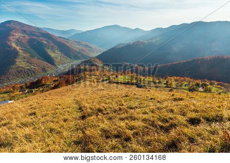 Autumn Carpathian Mountains Landscape With Multicolored Yellow-orange-red-brown Trees On Slope And  