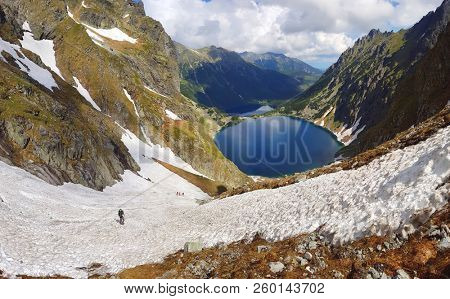 Morskie Oko. High Tatras, Poland, May 27, 2018. Beautiful landscape of snowy mountain tops and the lake between them. View from the mountain Rysy.