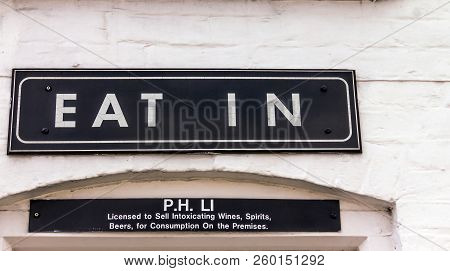 Stratford-upon-avon, Uk - June 8, 2015: Vintage Eat Out Sign In White Painted Brick Wall Of Restaura