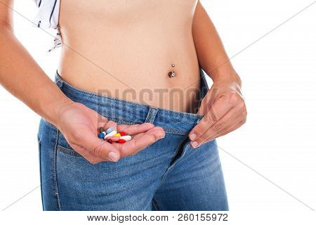 Close Up Picture Of Woman Holding Appetite Suppressants - Weight Loss