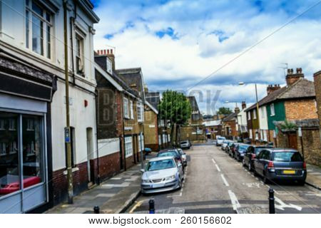 Blurred View Of Historic Buildings In Englih Style With Small Business Or Shops At Greenwich. London