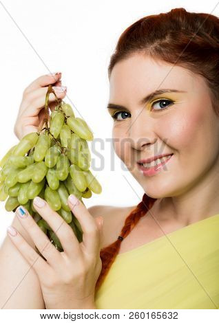 Beautiful Redhead Woman Licks Grapes. Concept Of Healthy Eating