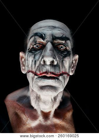 Bloody Halloween Theme: The Crazy Maniak Face On Dark Studio Background