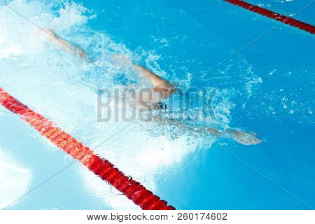 Image of man swimming under water in swimming pool