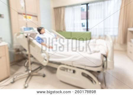 Patient On Hospital Bed, Medical Blur Interior Background White Room Ward With Nursing Care Or Healt