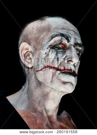 Bloody Halloween Theme: The Crazy Maniak Face On Dark Studio Background
