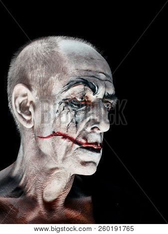 Bloody Halloween Theme: The Crazy Maniak Face On Dark Studio Background