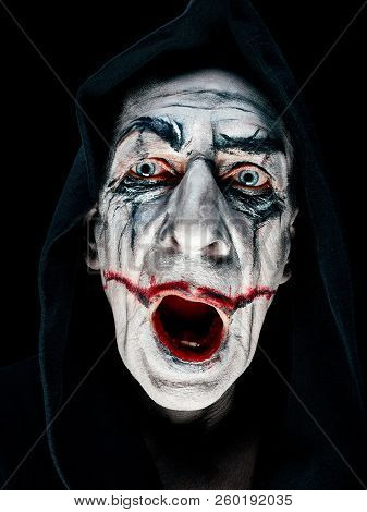 Bloody Halloween Theme: The Crazy Maniak Face On Dark Studio Background