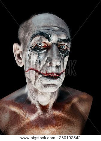 Bloody Halloween Theme: The Crazy Maniak Face On Dark Studio Background