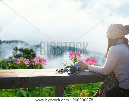 Smiling Asian Woman Drinking Coffee And Tea And Take A Photo And Relax In Sun Sitting Outdoor In Sun