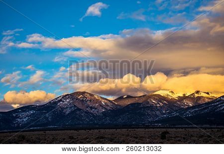 Golden Hour Sunset Peaks Above Taos New Mexico Winter Snow Covered Mountains Of The Rocky Mountains 