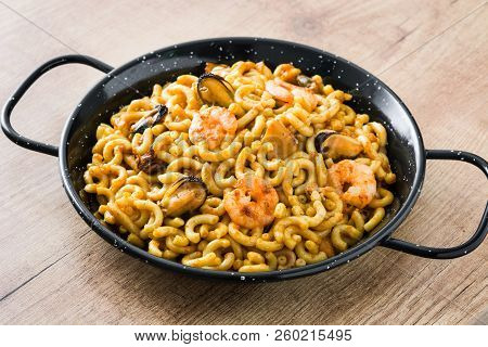 Traditional Spanish Fideua. Noodle Paella On Wooden Table