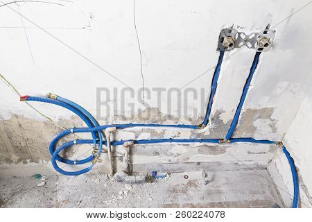Water Pipes Made Of Polypropylene Pex In The Wall, Plumbing In The House. Installation Of Sewer Pipe