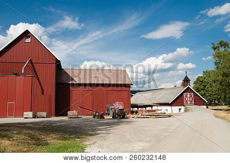 Backyard Of Red Farm Buildings Under Blue Sky, Hamar, Hedmark, Norway