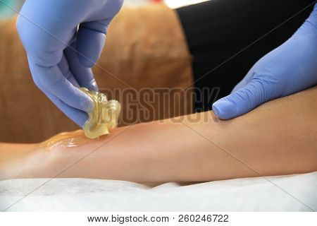 Beautician Removes Hair From A Woman's Hand.