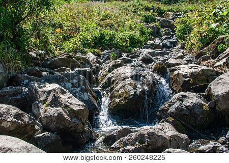 Mountain River Or Pretty Stoney Creek On Alps. Mountain Natural Landscape